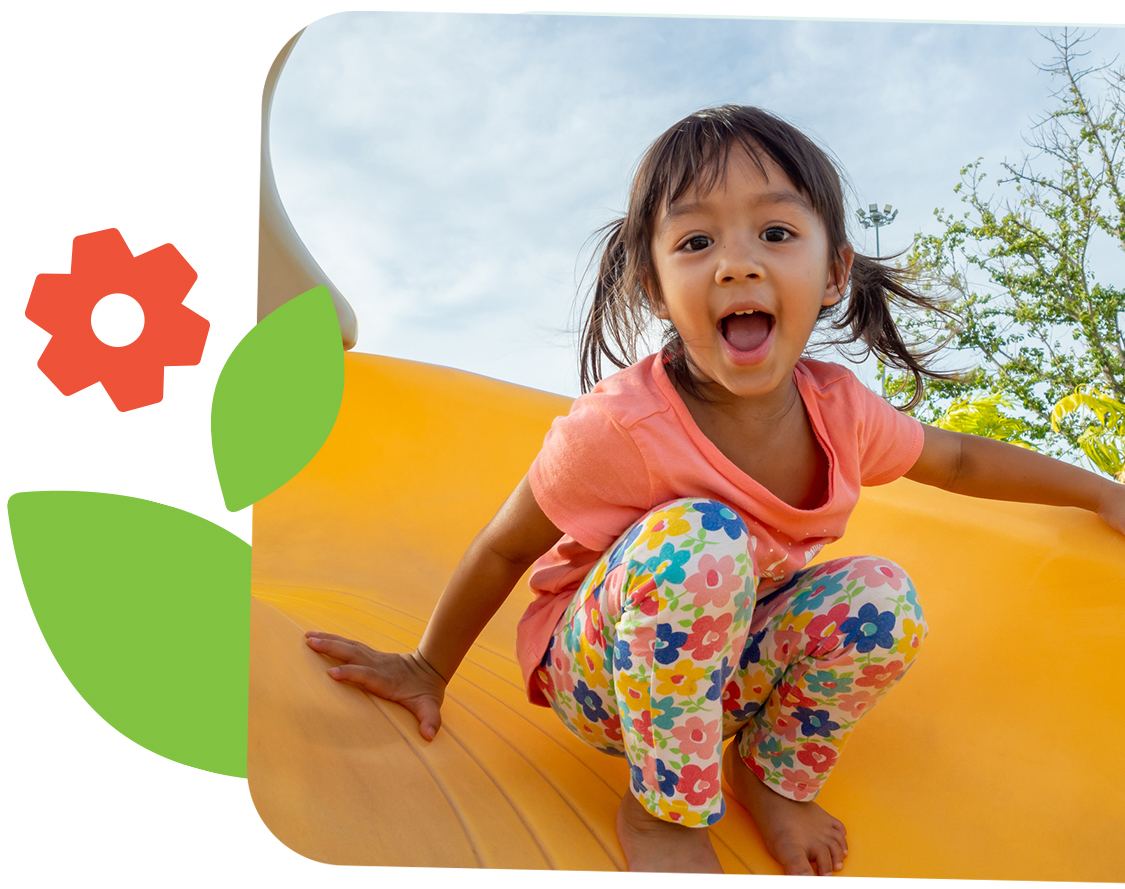 Young child playing on a slide.